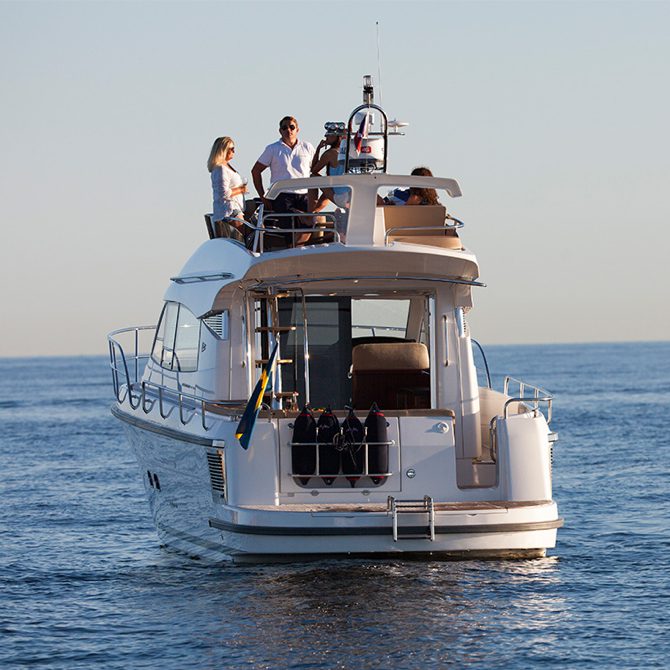 Nimbus boat on the ocean with people on the boat-roof