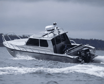 Boat driving fast in the ocean on a cloudy day